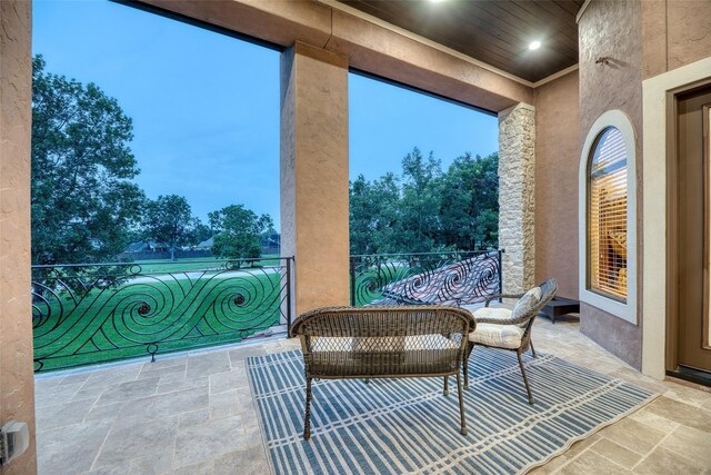 view of patio featuring a balcony and an outdoor living space