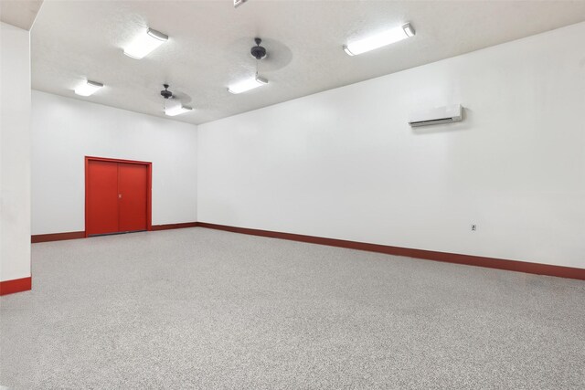 unfurnished room featuring a textured ceiling and carpet