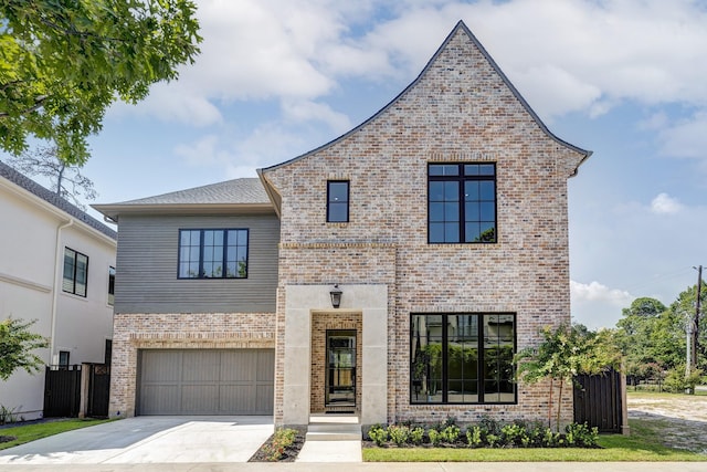 view of front facade with an attached garage, concrete driveway, and brick siding