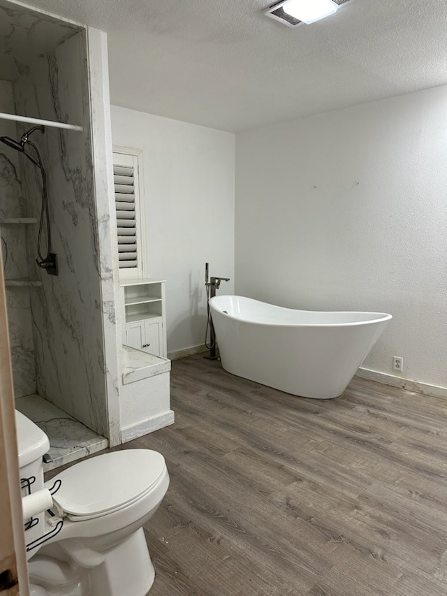 full bathroom with a textured ceiling, vanity, hardwood / wood-style flooring, independent shower and bath, and toilet