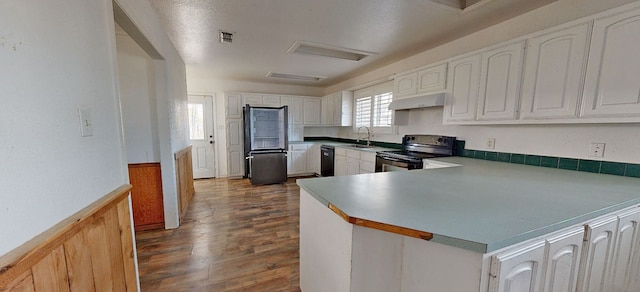 kitchen with kitchen peninsula, sink, black appliances, dark hardwood / wood-style floors, and white cabinetry