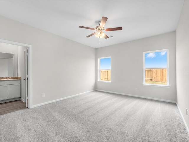 carpeted empty room with ceiling fan