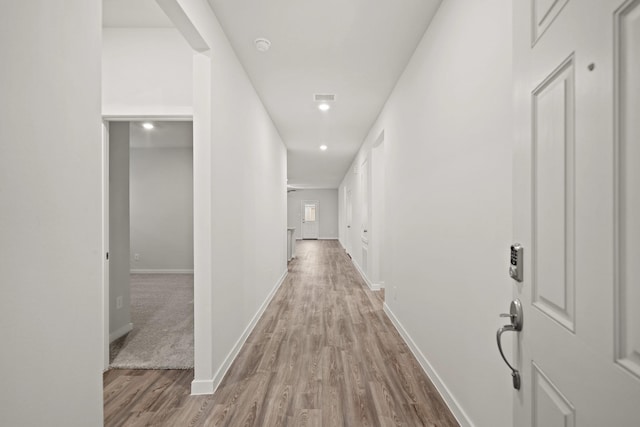 hall with light hardwood / wood-style flooring