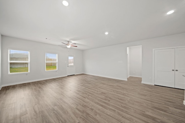 spare room with ceiling fan and hardwood / wood-style flooring