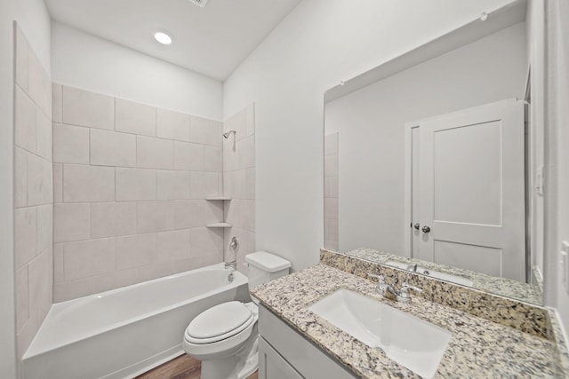 full bathroom featuring vanity, toilet, wood-type flooring, and tiled shower / bath