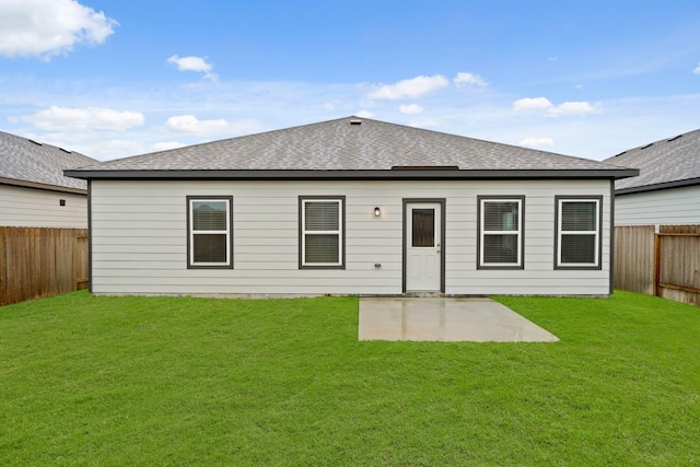 rear view of property featuring a yard and a patio