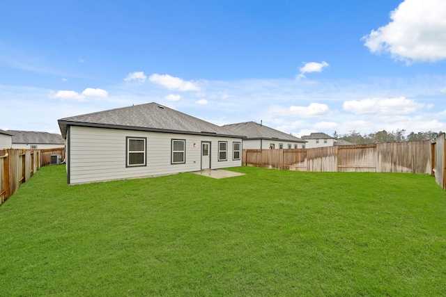 rear view of property with a lawn