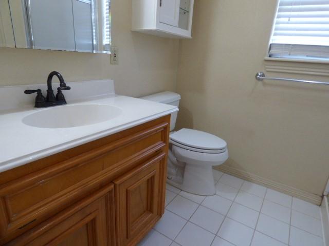 bathroom with tile patterned floors, vanity, and toilet