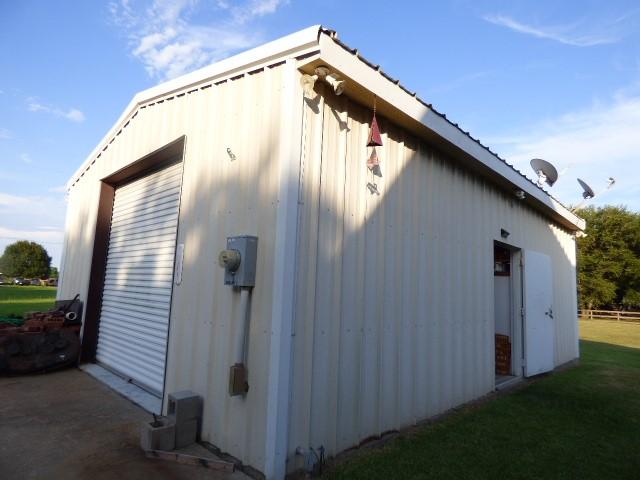 view of home's exterior with an outbuilding and a yard