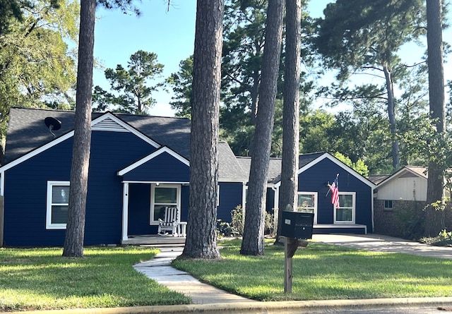 view of front of house with a front lawn and a porch