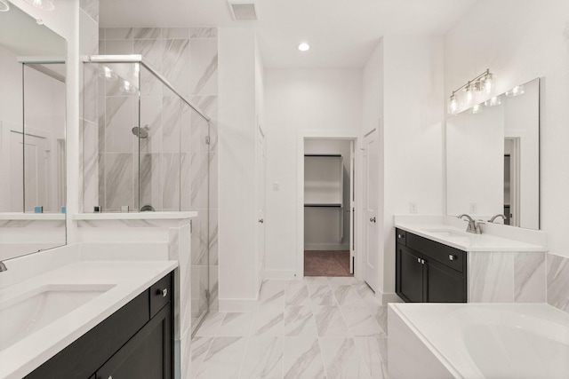 full bath featuring a stall shower, visible vents, a sink, and a spacious closet