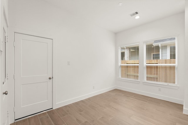 spare room with baseboards, recessed lighting, visible vents, and light wood-style floors