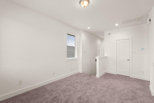 spare room featuring baseboards, carpet flooring, visible vents, and recessed lighting