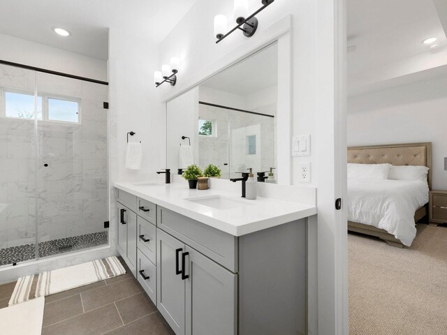 bathroom with double vanity, an enclosed shower, and tile patterned floors