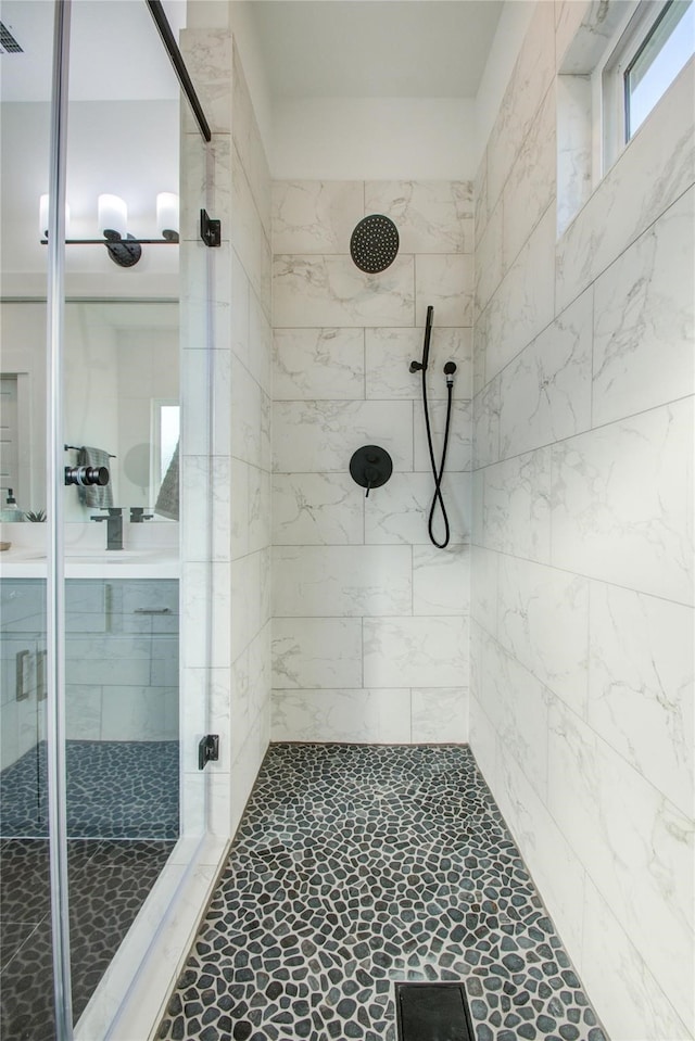 bathroom with a tile shower