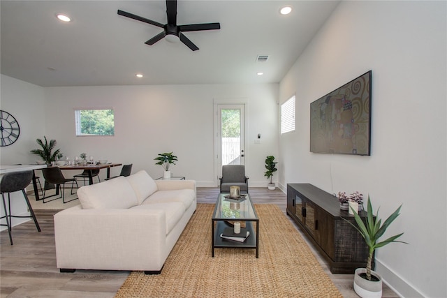 living room featuring ceiling fan and light hardwood / wood-style floors