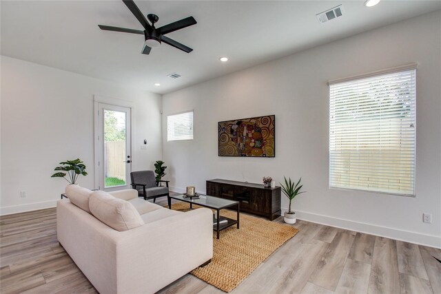 living room featuring ceiling fan and light hardwood / wood-style floors