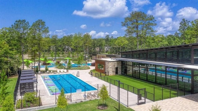 view of pool featuring a lawn