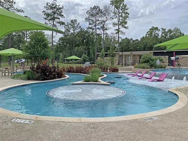 view of swimming pool with a patio and pool water feature