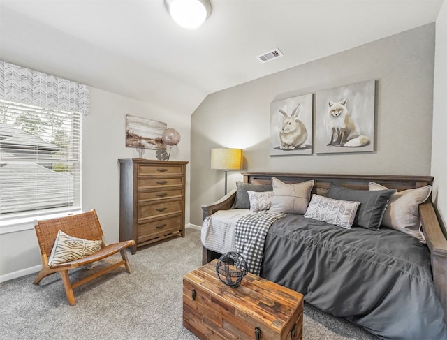 carpeted bedroom with vaulted ceiling