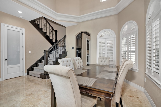 tiled dining area with a towering ceiling