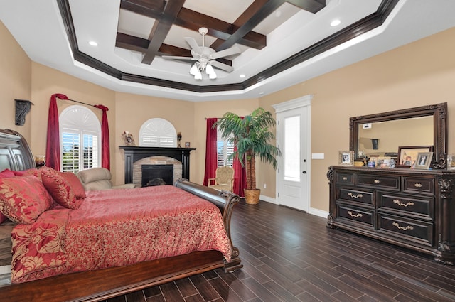 bedroom with coffered ceiling, dark wood-type flooring, a tray ceiling, and ceiling fan