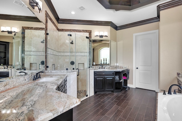 bathroom with ornamental molding, double vanity, and plus walk in shower