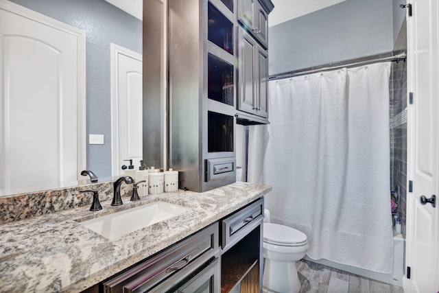 full bathroom featuring shower / bath combo, toilet, vanity, and hardwood / wood-style floors