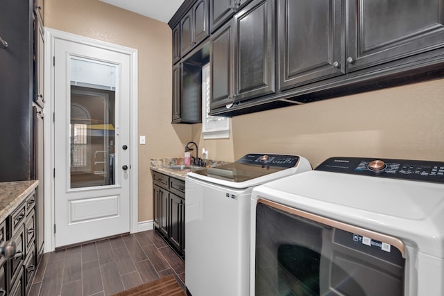 laundry area with cabinets, sink, dark wood-type flooring, and separate washer and dryer