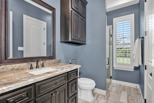 bathroom featuring hardwood / wood-style flooring, vanity, and toilet