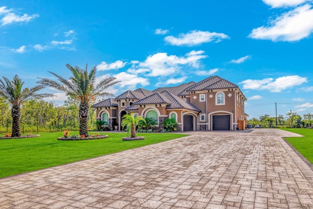 mediterranean / spanish-style home with a front lawn and a garage