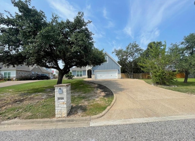 view of front facade with a garage and a front lawn