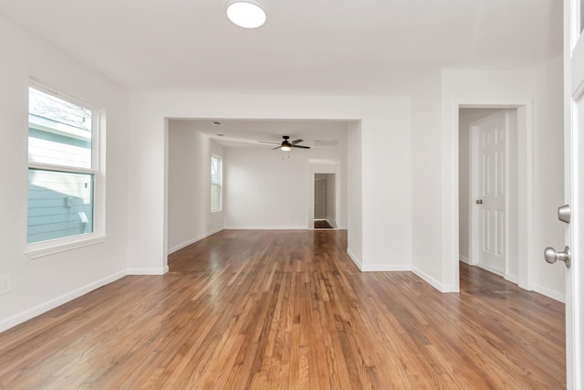 unfurnished living room with ceiling fan and light wood-type flooring