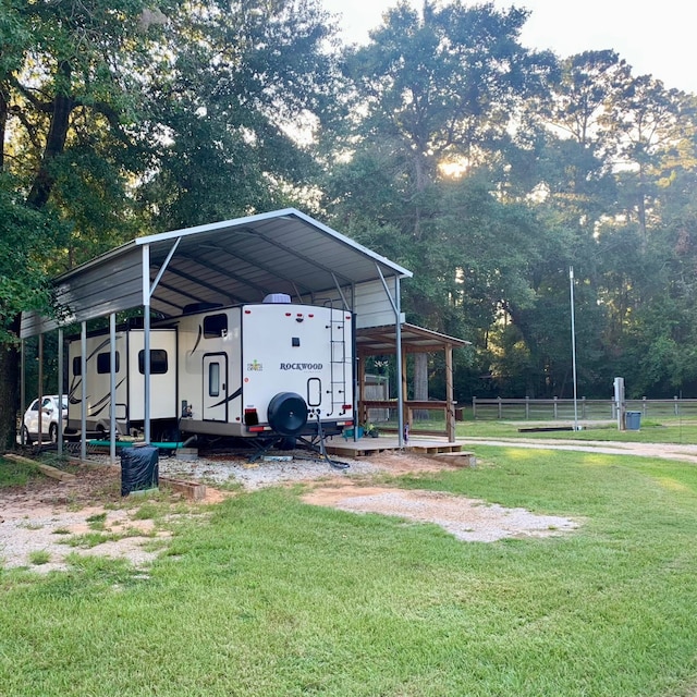 view of outbuilding with a carport and a yard