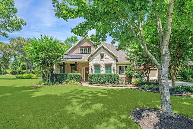 craftsman inspired home with a front lawn