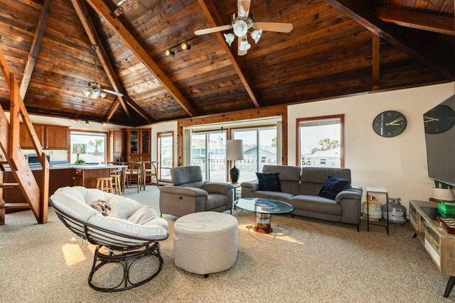 living room with beamed ceiling, ceiling fan, carpet, and wooden ceiling