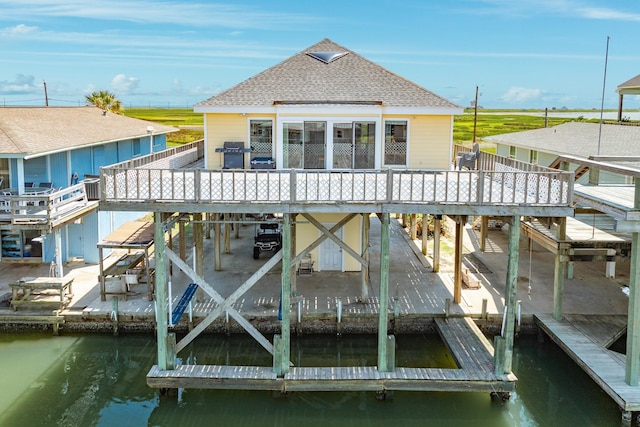 view of dock featuring a deck with water view