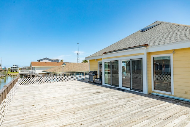 deck featuring a water view and area for grilling