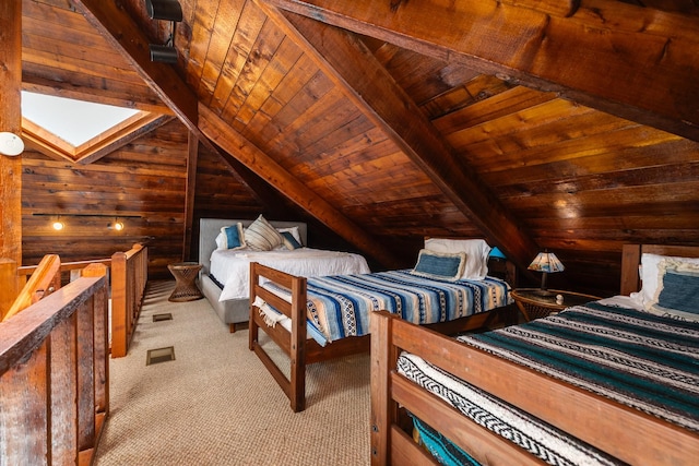 bedroom with vaulted ceiling with skylight, wood ceiling, light colored carpet, and wooden walls