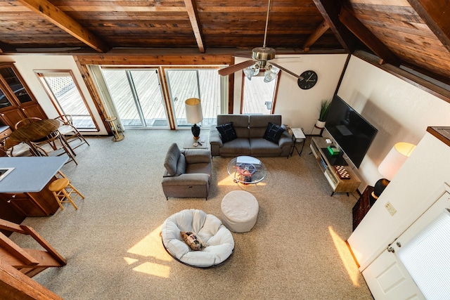 unfurnished living room with a ceiling fan, carpet, wooden ceiling, and lofted ceiling with beams