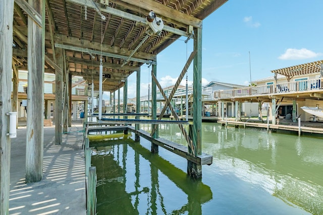 dock area with a water view and boat lift