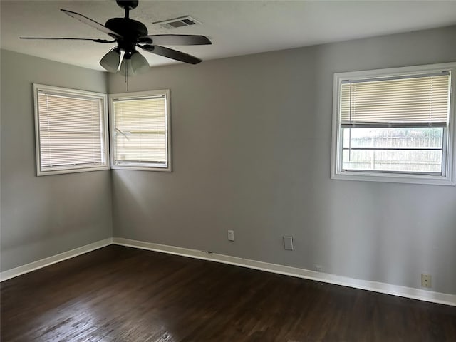 empty room featuring ceiling fan and dark wood-type flooring