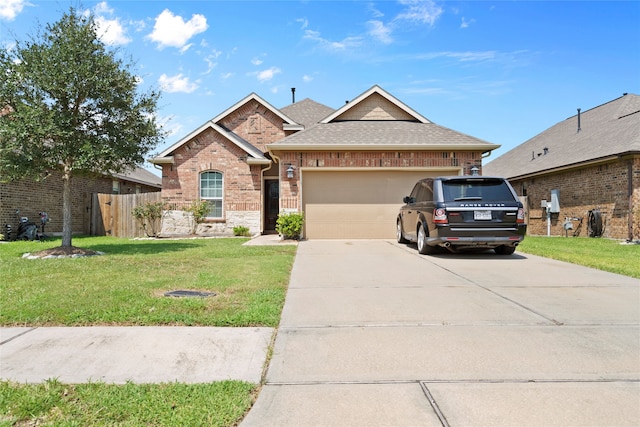 view of front of home with a front yard and a garage