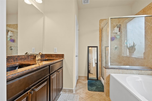 bathroom featuring dual vanity, shower with separate bathtub, and tile patterned flooring