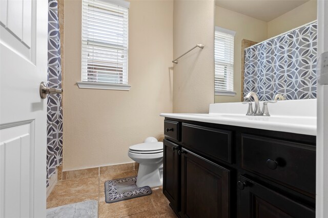 bathroom with vanity, toilet, and tile patterned flooring