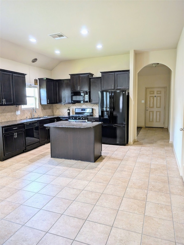 kitchen featuring light tile patterned flooring, backsplash, a center island, black appliances, and sink