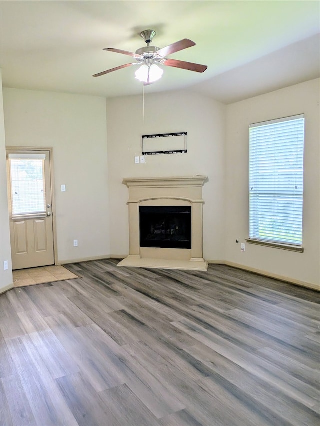 unfurnished living room with light hardwood / wood-style flooring and ceiling fan