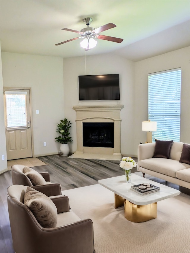 living room featuring ceiling fan and light hardwood / wood-style flooring