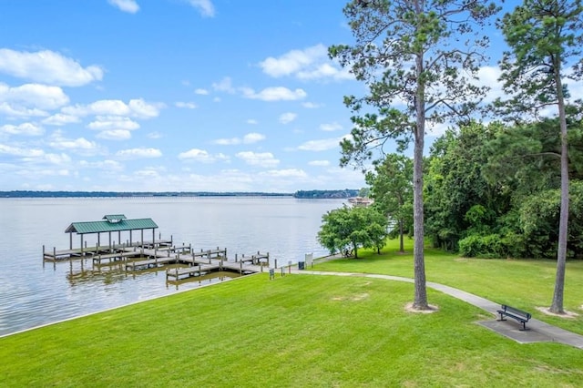 view of dock with a water view and a yard