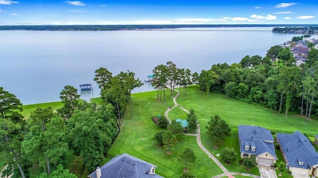 birds eye view of property with a water view